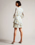SUZIIEE-Dresses-Make every day a fashion show in SUZIIEE. Featuring our gorgeous poppy print and all the ruffles your heart desires, this versatile mini dress will take you from coffee mornings to dinner dates with ease.The fabric of this product is made with 30% recycled polyester. Using recycled polyester helps divert plastic waste from ending in landfills, and helps us to reduce our dependence on virgin materials. Mini dress Daisy print Long blouson sleeves Asymmetric ruffled hem Self tie neckline Zip fa